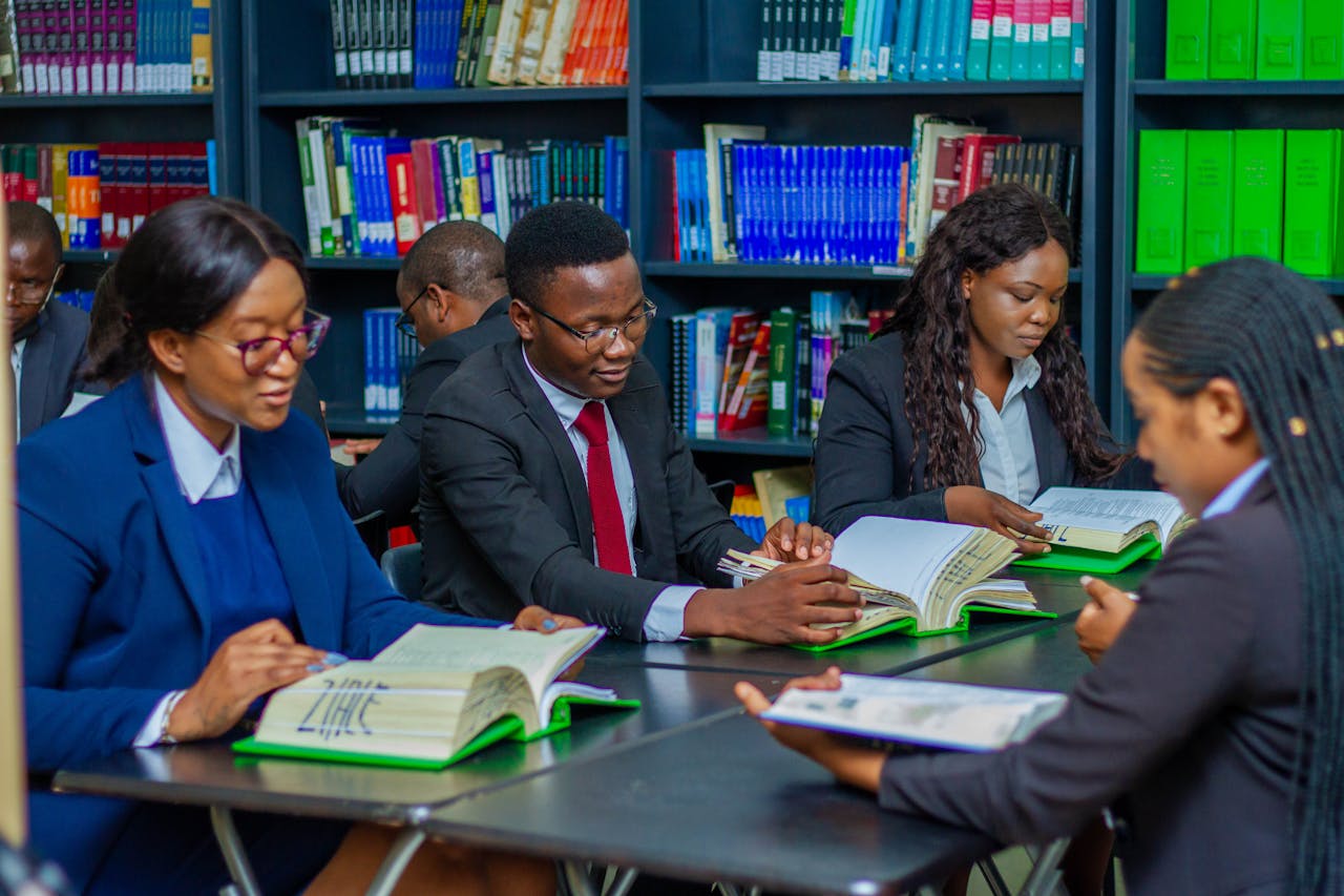 cta-02 Focused group of adults studying in a library, fostering education and collaboration.