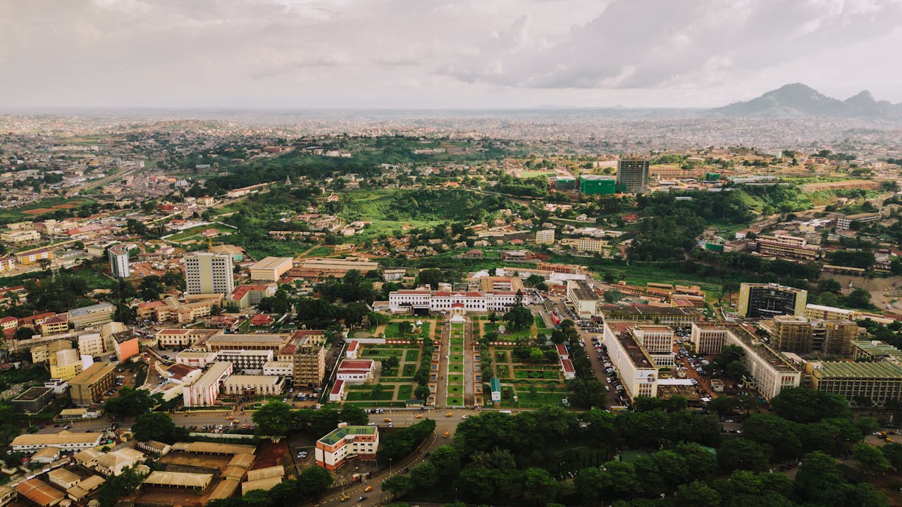 portfolio-06 Aerial view of lush Yaoundé cityscape showcasing urban and green landscapes.