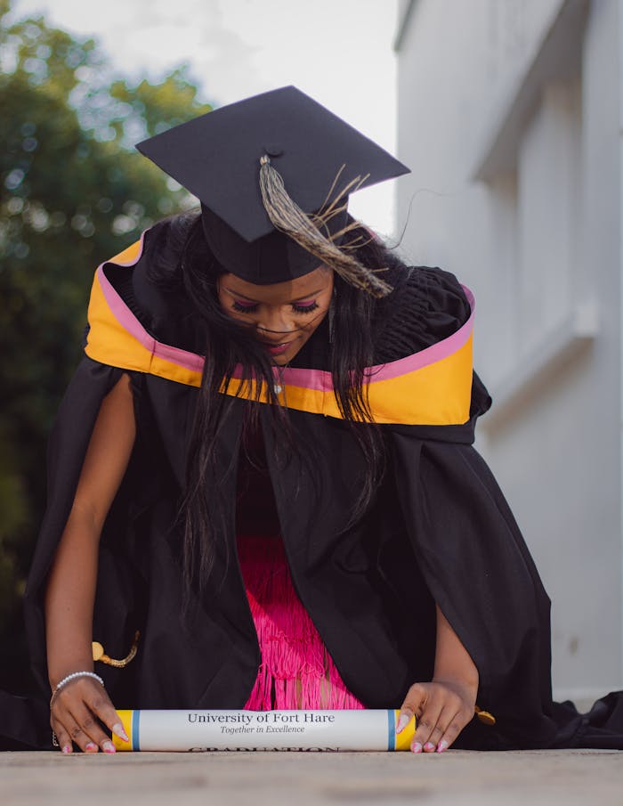 portfolio-04 A proud graduate from the University of Fort Hare with diploma and cap, celebrating achievement.