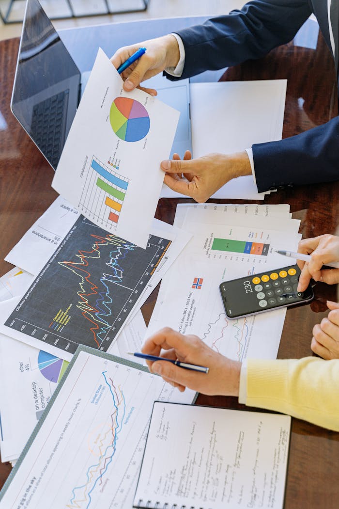 gallery-02 Business professionals analyzing financial charts and graphs during a meeting.