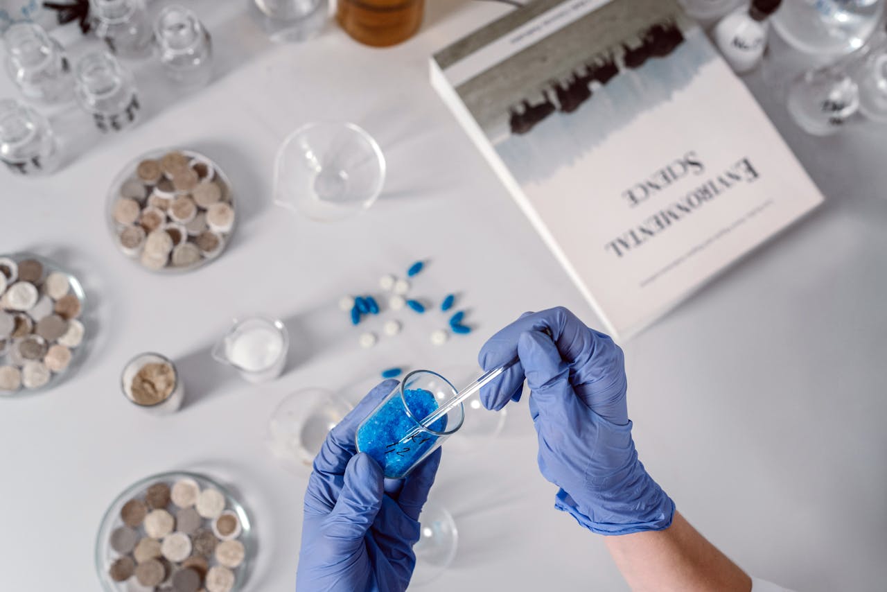 Crafting Captivating Headlines: Your awesome post title goes here Top view of a scientist using a dropper with blue chemicals surrounded by laboratory equipment.